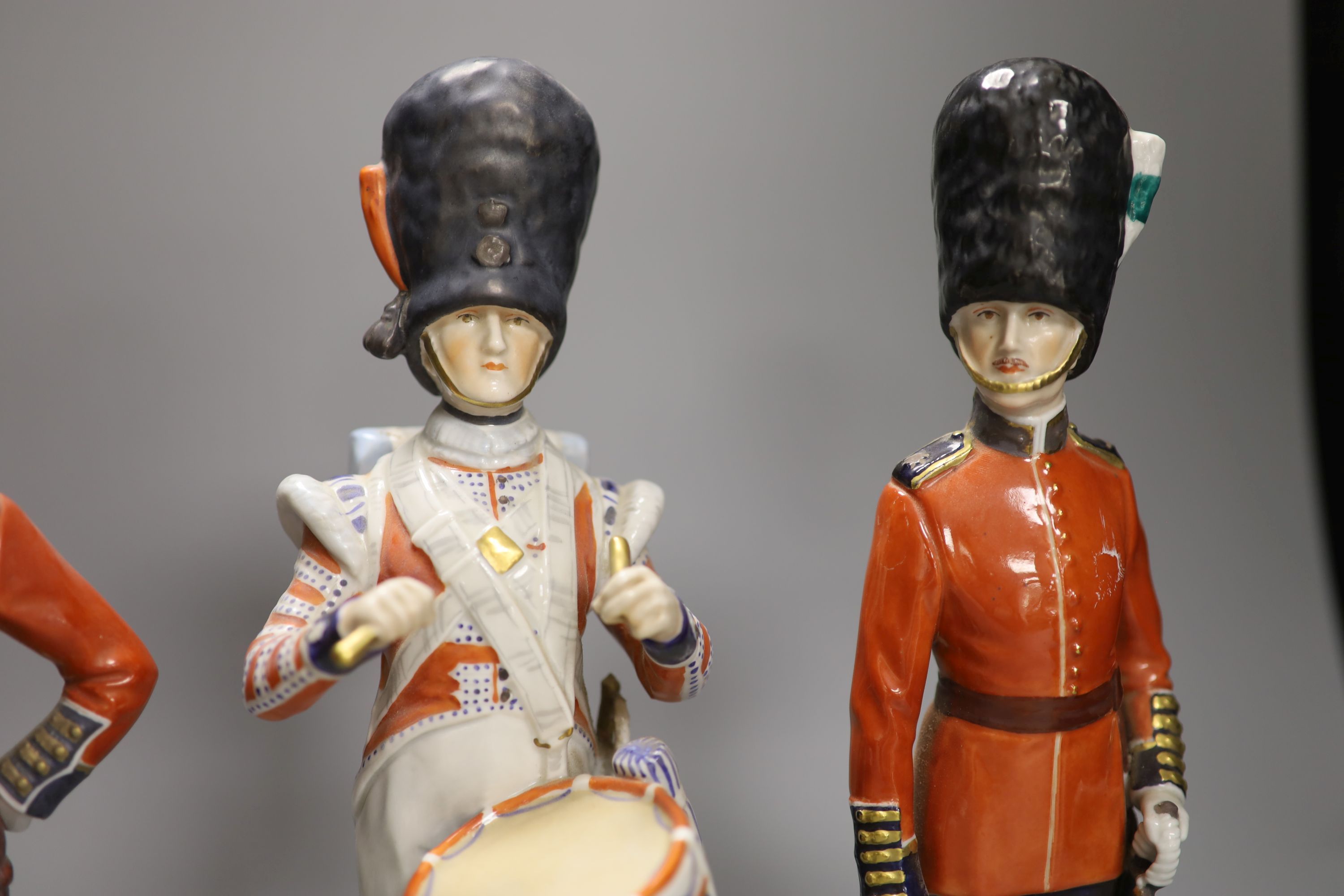 Four Dresden porcelain models of soldiers: Irish Guards, Drummer 3rd Guards, The Welsh Guards and Gordon Highlanders, height 28cm